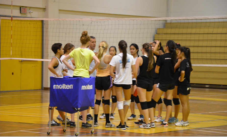 The+girls+Varsity+volleyball+team+have+a+team+talk%2C+photo+by+Stella+Kim