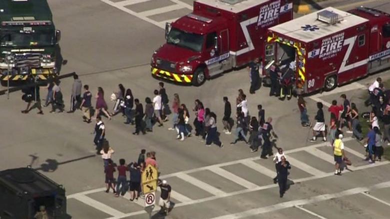 Students are evacuated from Marjory Stoneman Douglas High School during a shooting incident in Parkland, Florida, February 14, 2018 in a still image from video. WSVN.com via REUTERS