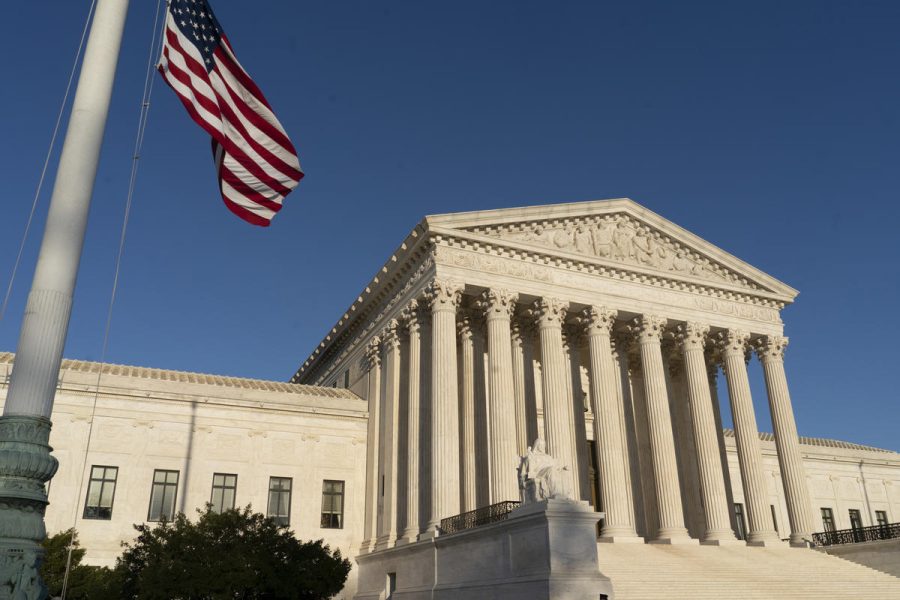 In this April 20, 2018 file photo, the Supreme Court is seen in Washington.  The Supreme Court is setting aside a Colorado court ruling against a baker who wouldn’t make a wedding cake for a same-sex couple. But the court is not deciding the big issue in the case, whether a business can refuse to serve gay and lesbian people.  (AP Photo/J. Scott Applewhite)