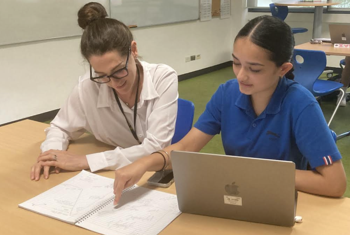 Creative Writing teacher Farrah Collette conferences during class with freshman Mehma Kaur Singh.