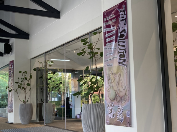 Outside the 2026 IB Art Exhibition, The Solution, with a banner by Cindy Yang.